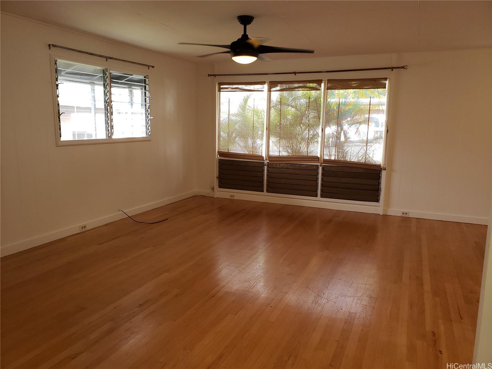 2313 Star Road, Unit A Honolulu, HI 96813 - Photo 5 of 21 an empty room with wooden floor and windows