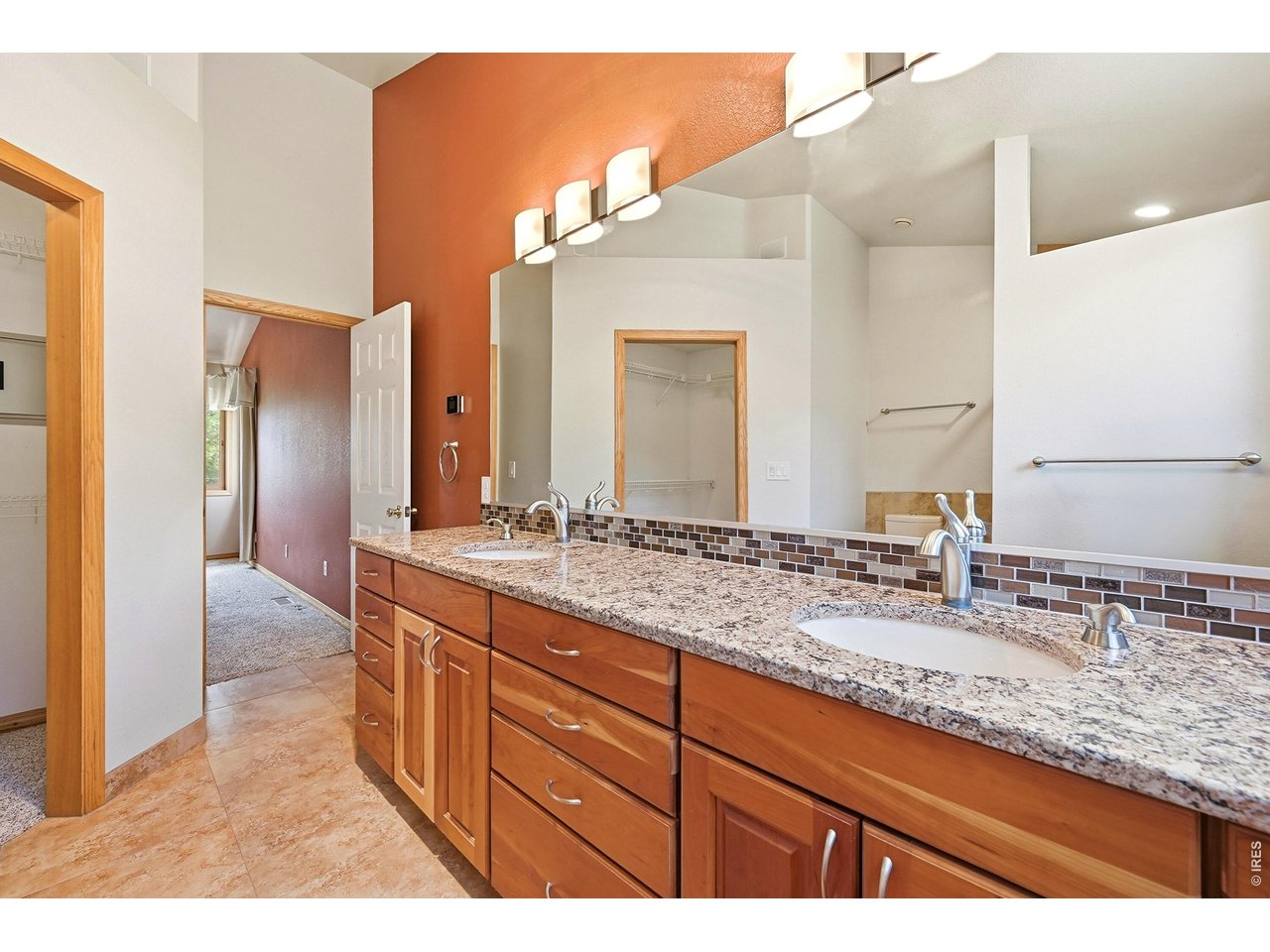 256 Choctaw Road Lyons, CO 80540 - Photo 30 of 50 a bathroom with a granite countertop sink and a mirror
