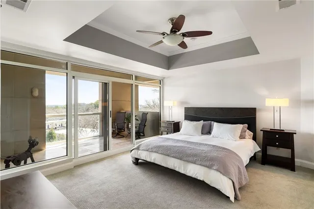 a bedroom with a large bed and a large window