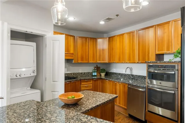 a kitchen with a sink a stove and cabinets