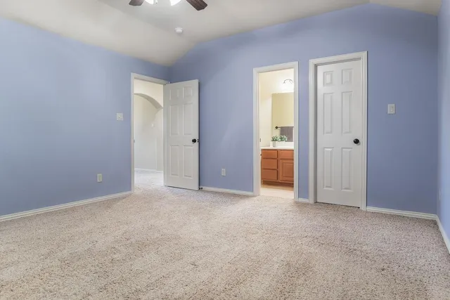an empty room with windows and closet