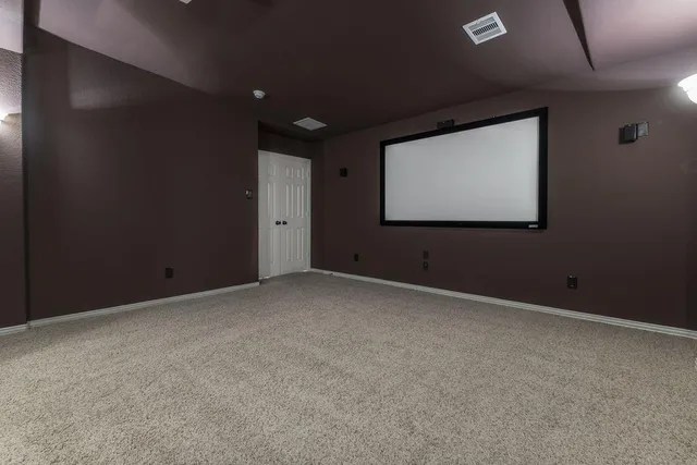 an empty room with closet and windows