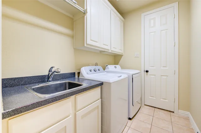 front view of a house with a yard and potted plants