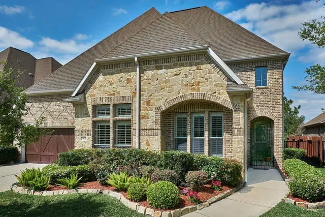 a front view of a house with garden