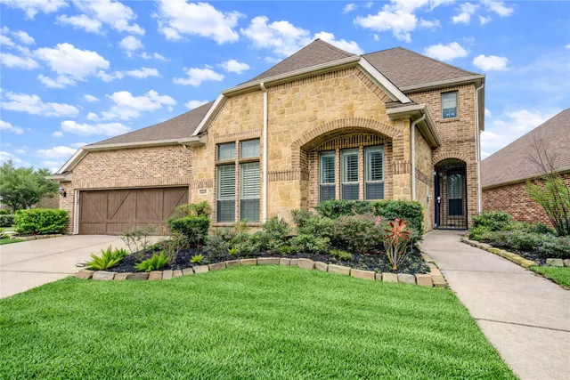 an empty room with wooden floor fireplace and windows
