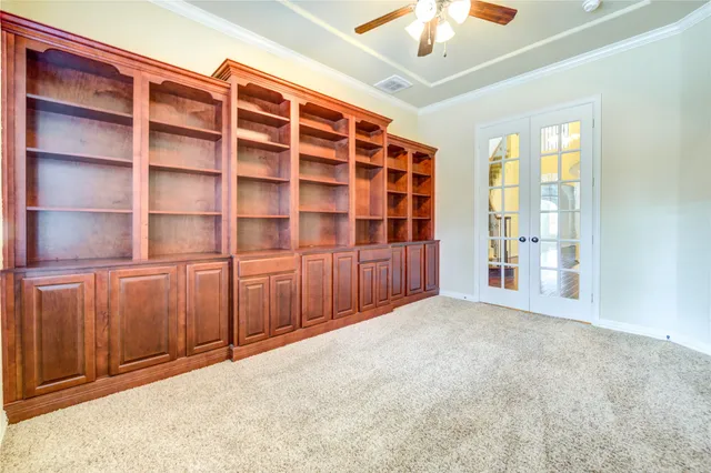 a kitchen with kitchen island granite countertop a sink a counter top space stainless steel appliances and cabinets