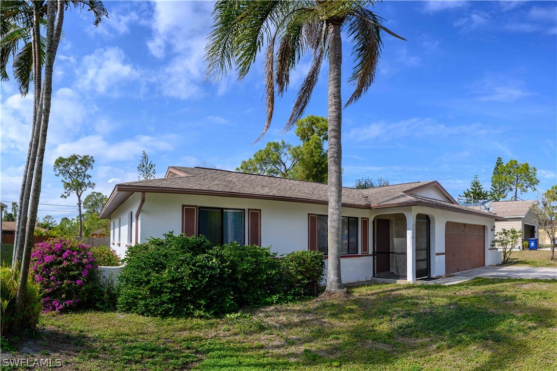 18430 Hepatica Road Fort Myers, FL 33967 - Photo 1 of 16 a front view of house with yard and green space