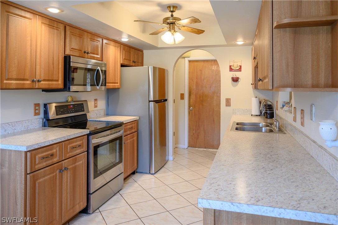 18430 Hepatica Road Fort Myers, FL 33967 - Photo 3 of 16 a kitchen with stainless steel appliances granite countertop a refrigerator a stove and a sink with cabinets