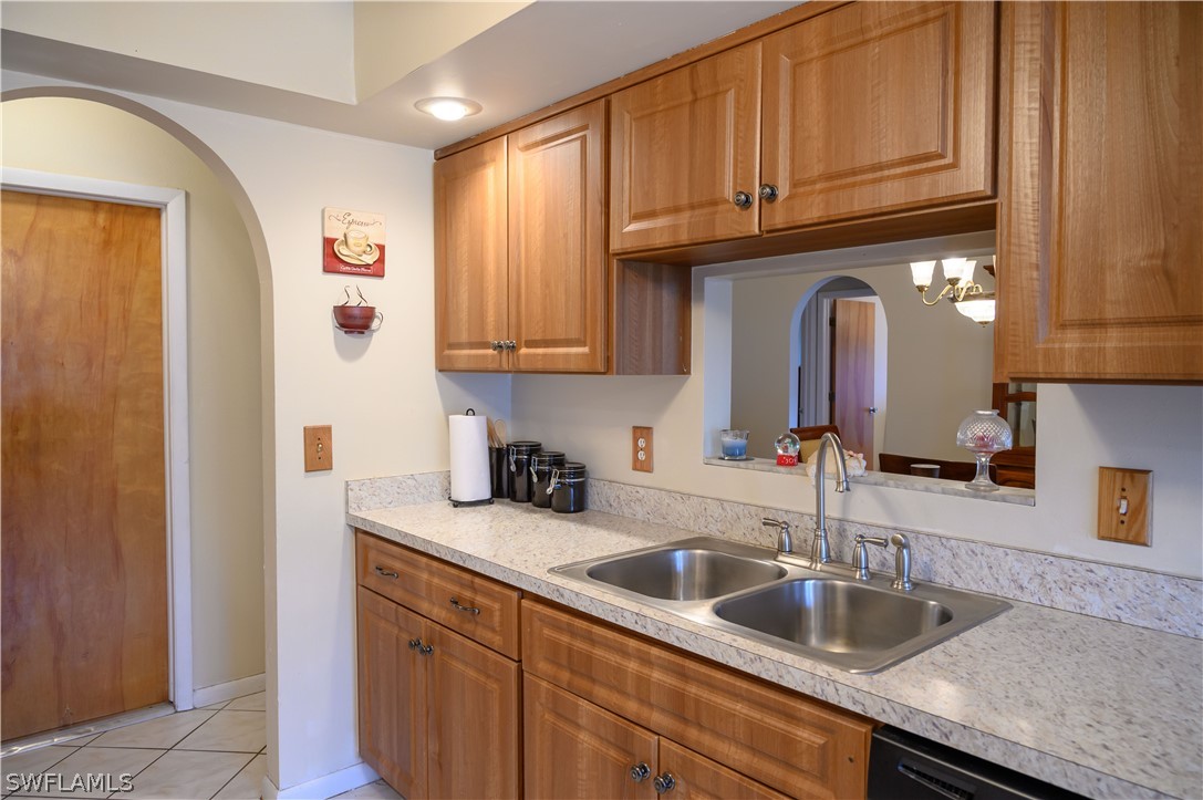 18430 Hepatica Road Fort Myers, FL 33967 - Photo 4 of 16 a kitchen with granite countertop a sink a stove and cabinets
