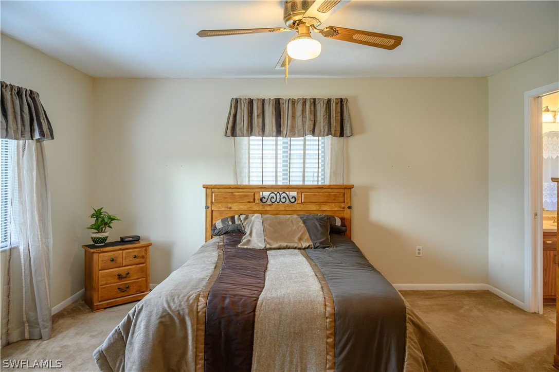18430 Hepatica Road Fort Myers, FL 33967 - Photo 7 of 16 a bedroom with a bed and a chandelier