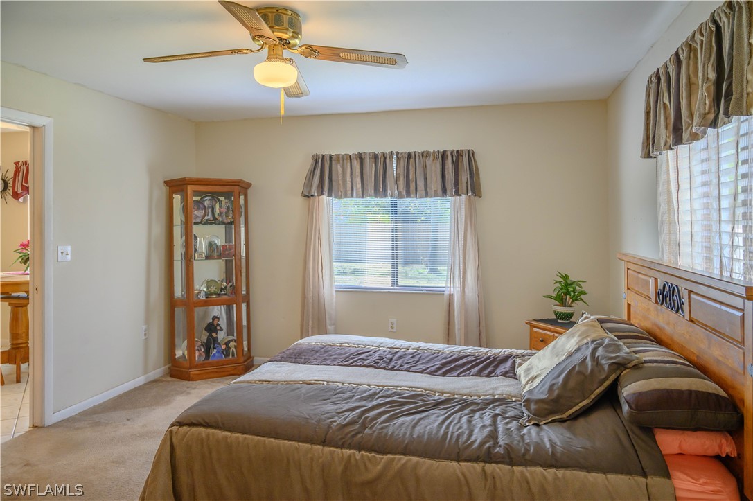 18430 Hepatica Road Fort Myers, FL 33967 - Photo 8 of 16 a bedroom with a bed and a window