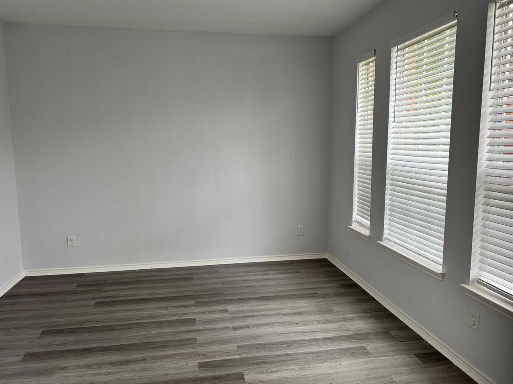 4312 Ridge Point Lane Plano, TX 75024 - Photo 14 of 16 a view of an empty room with wooden floor and a window