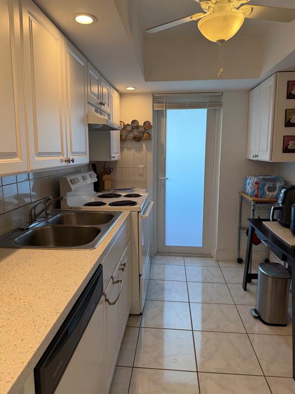 4502 North Federal Highway, Unit 235D Lighthouse Point, FL 33064 - Photo 11 of 40 a kitchen with a sink appliances and cabinets
