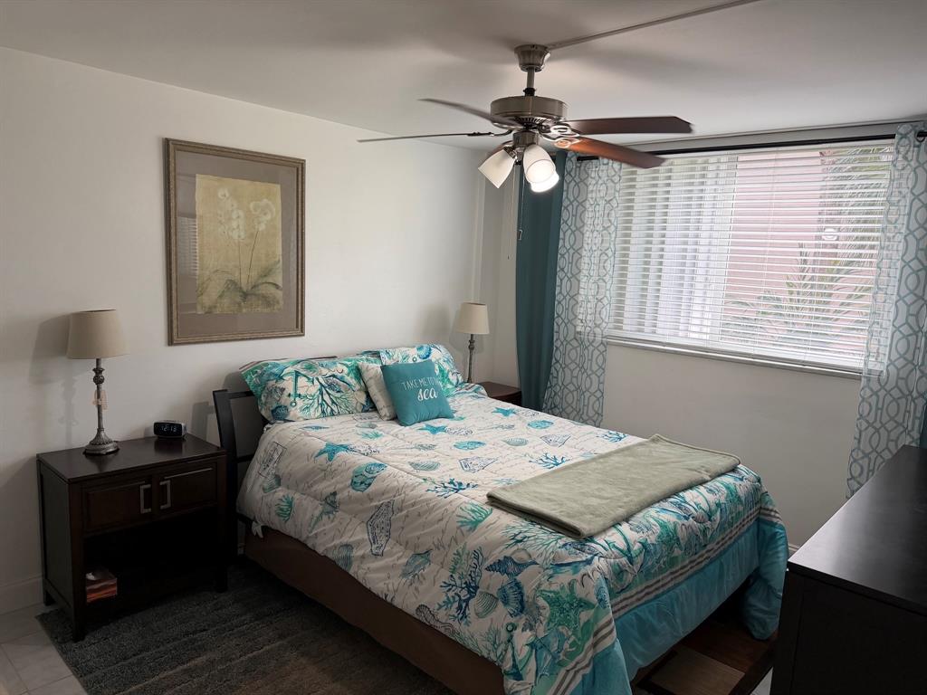 4502 North Federal Highway, Unit 235D Lighthouse Point, FL 33064 - Photo 13 of 40 a bedroom that has a bed and a table in it