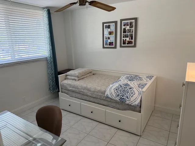 a bedroom with a bed and a chair
