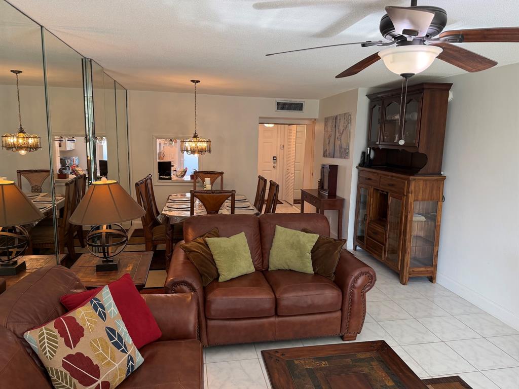 4502 North Federal Highway, Unit 235D Lighthouse Point, FL 33064 - Photo 2 of 40 a living room with furniture a ceiling fan and a window
