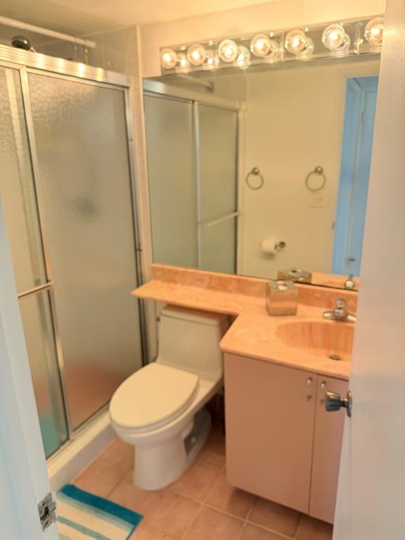 4502 North Federal Highway, Unit 235D Lighthouse Point, FL 33064 - Photo 22 of 40 a bathroom with a sink a toilet a mirror and shower