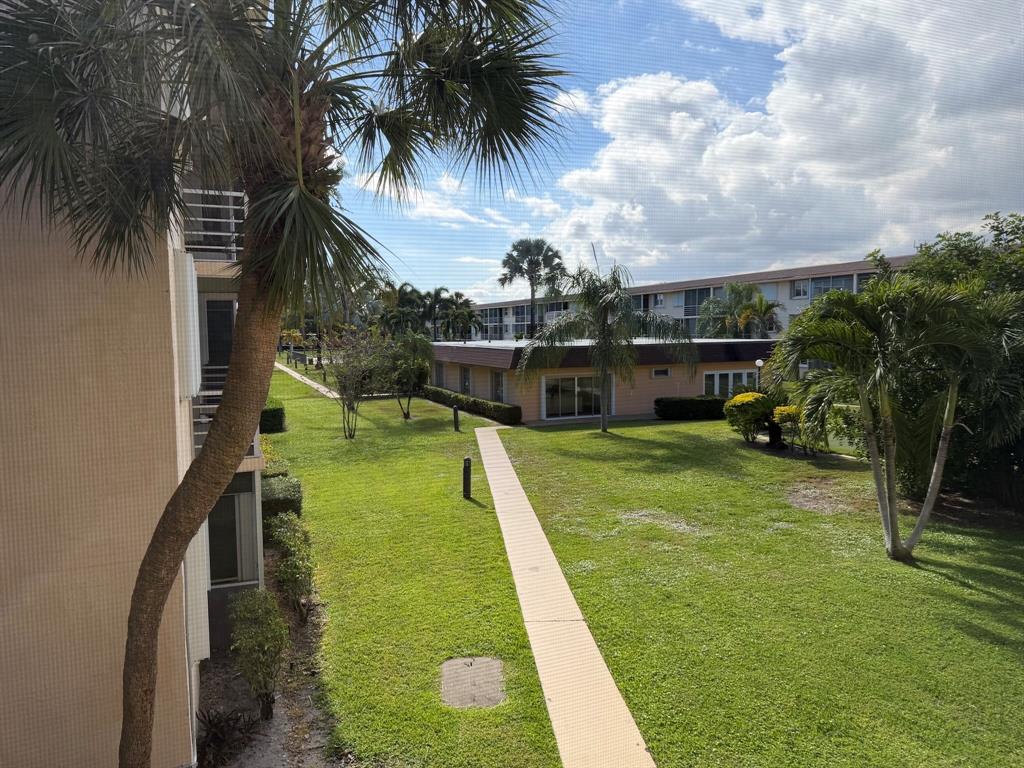 4502 North Federal Highway, Unit 235D Lighthouse Point, FL 33064 - Photo 25 of 40 a swimming pool with outdoor seating and garden