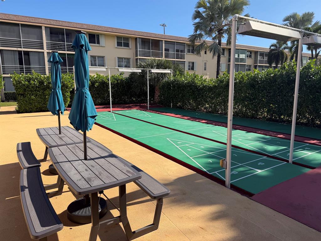 4502 North Federal Highway, Unit 235D Lighthouse Point, FL 33064 - Photo 27 of 40 a view of a patio with a table chairs and a backyard