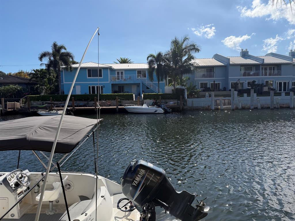 4502 North Federal Highway, Unit 235D Lighthouse Point, FL 33064 - Photo 36 of 40 a view of a balcony with chairs and potted plants
