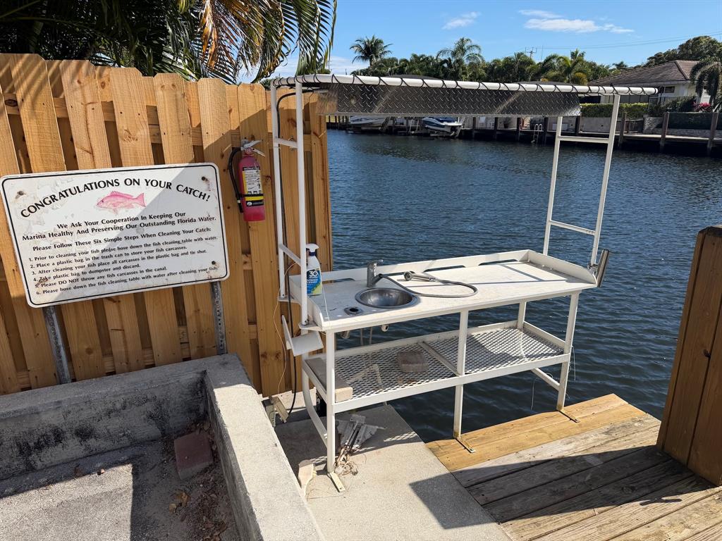 4502 North Federal Highway, Unit 235D Lighthouse Point, FL 33064 - Photo 40 of 40 a view of a patio with table and chairs with wooden floor and fence