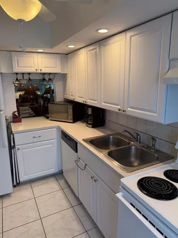 a kitchen with a sink cabinets and appliances