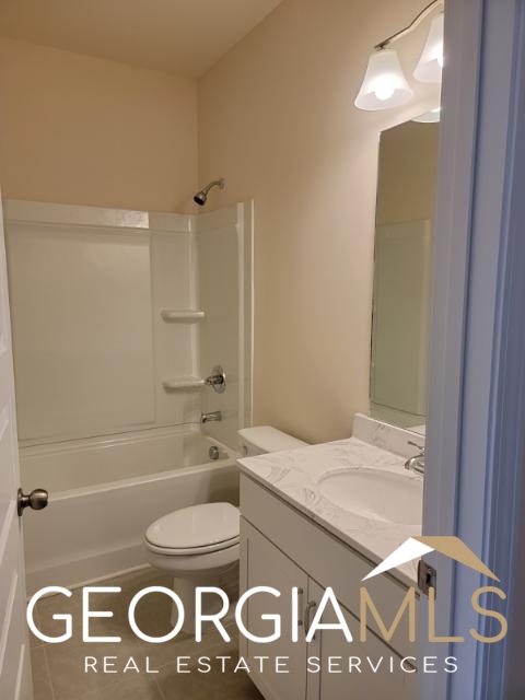 160 Madison Bend Holly Springs, GA 30188 - Photo 13 of 18 a bathroom with a sink a toilet and shower
