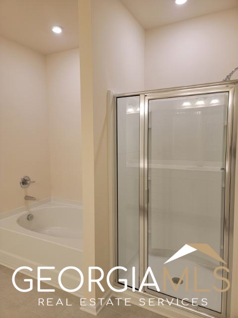 160 Madison Bend Holly Springs, GA 30188 - Photo 16 of 18 a bathroom with a shower