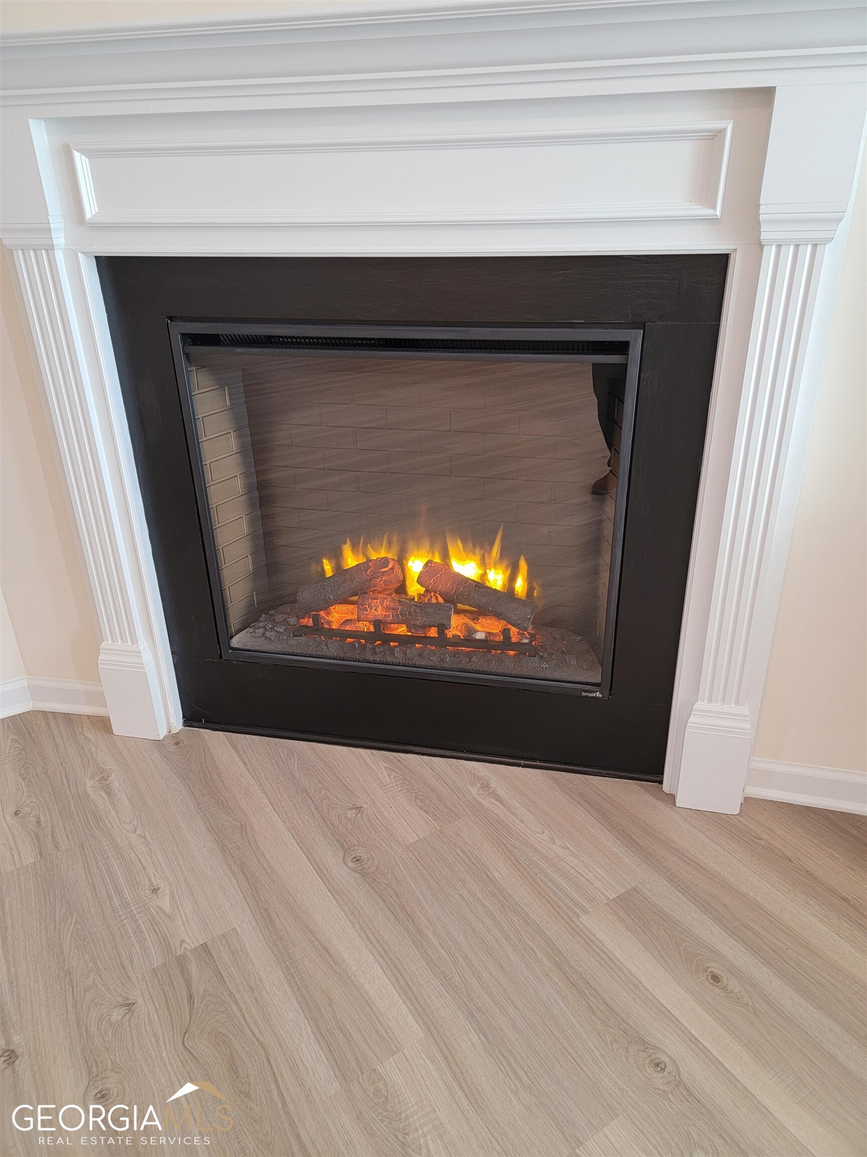 160 Madison Bend Holly Springs, GA 30188 - Photo 6 of 18 a view of fireplace and wooden floor