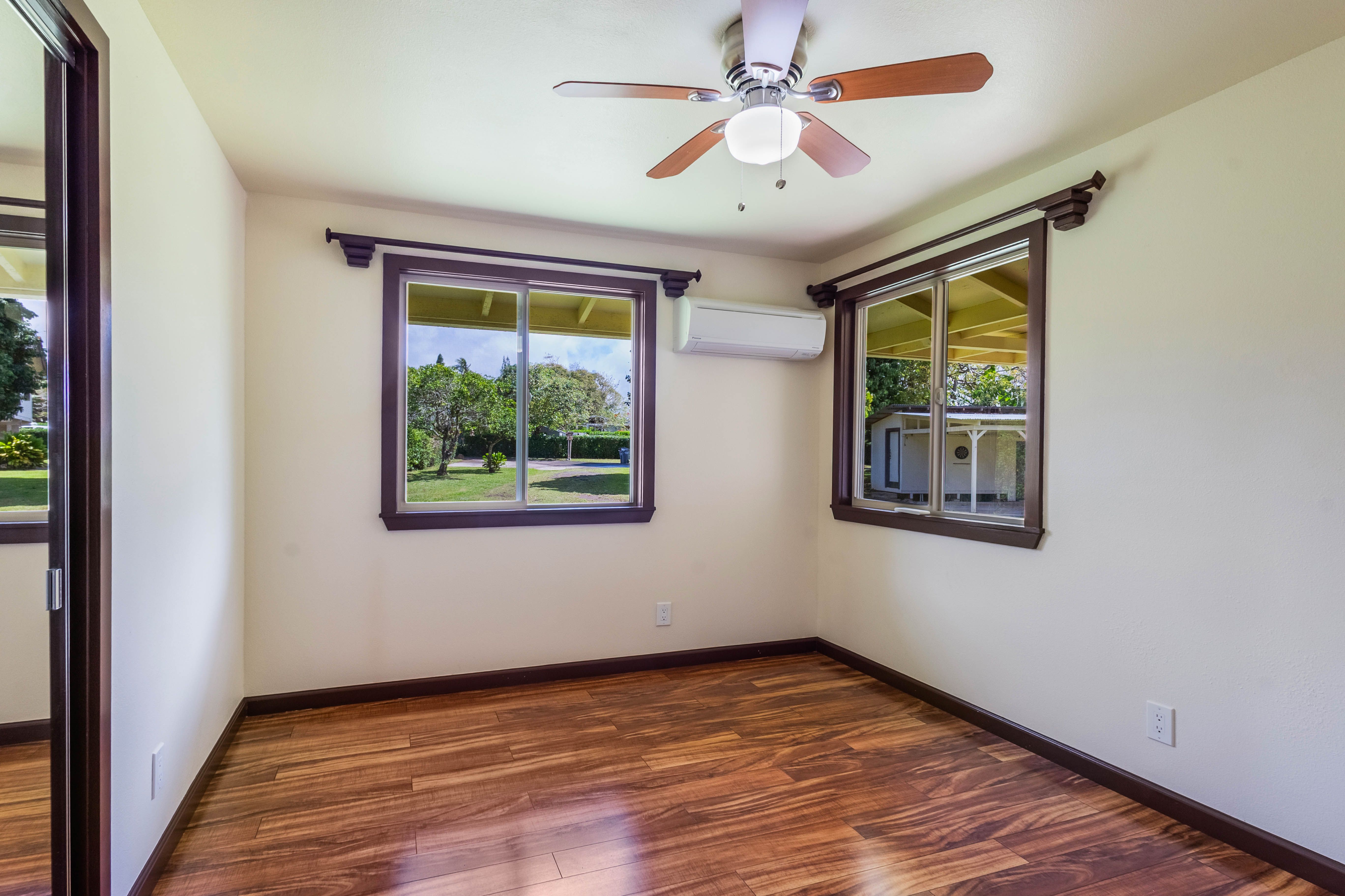 4085 B Noho Road Koloa, HI 96756 - Photo 13 of 30 a view of an empty room with wooden floor and a window