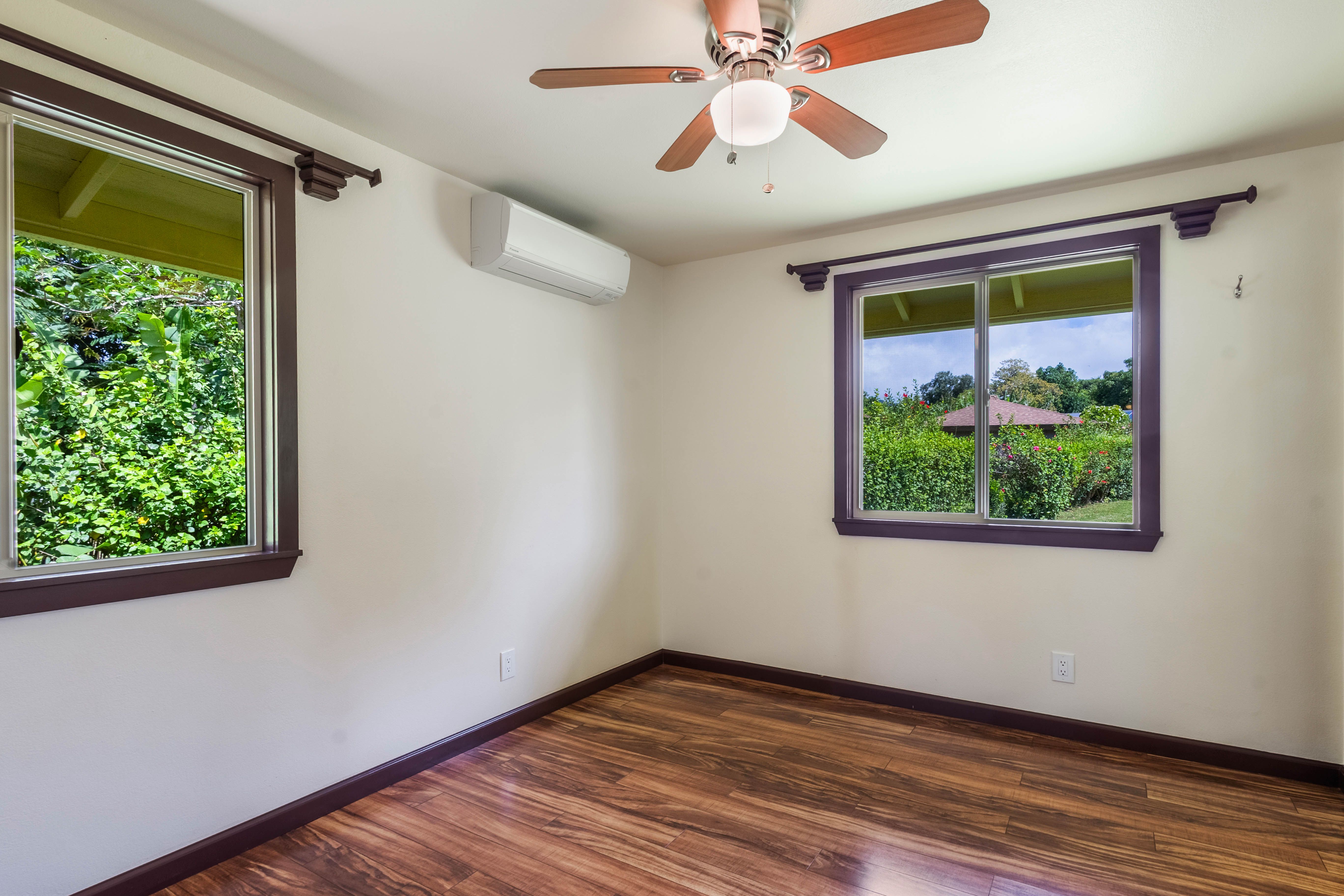 4085 B Noho Road Koloa, HI 96756 - Photo 14 of 30 a view of an empty room with wooden floor and a window