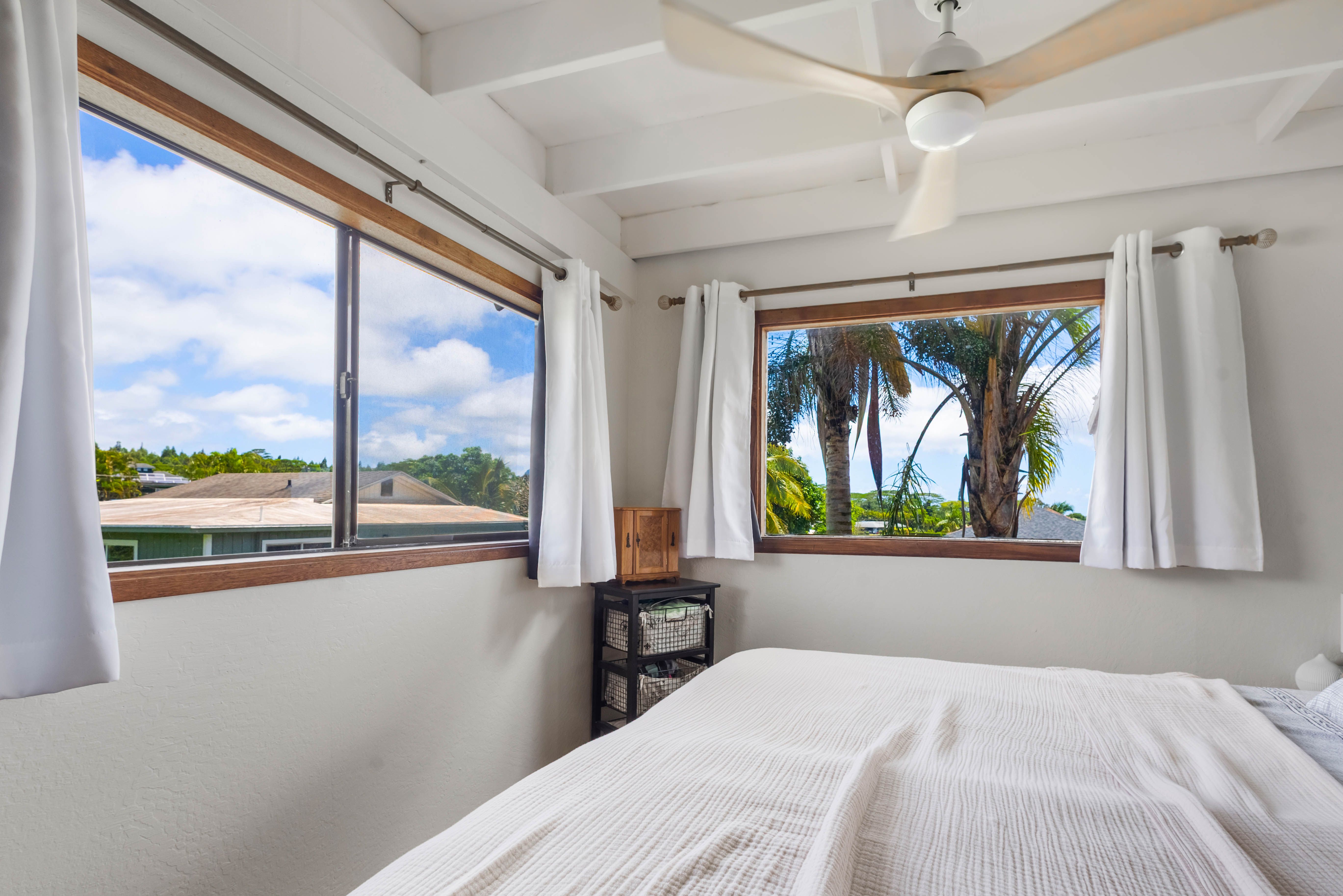 4085 B Noho Road Koloa, HI 96756 - Photo 27 of 30 a bedroom with a bed and a large window with outer view