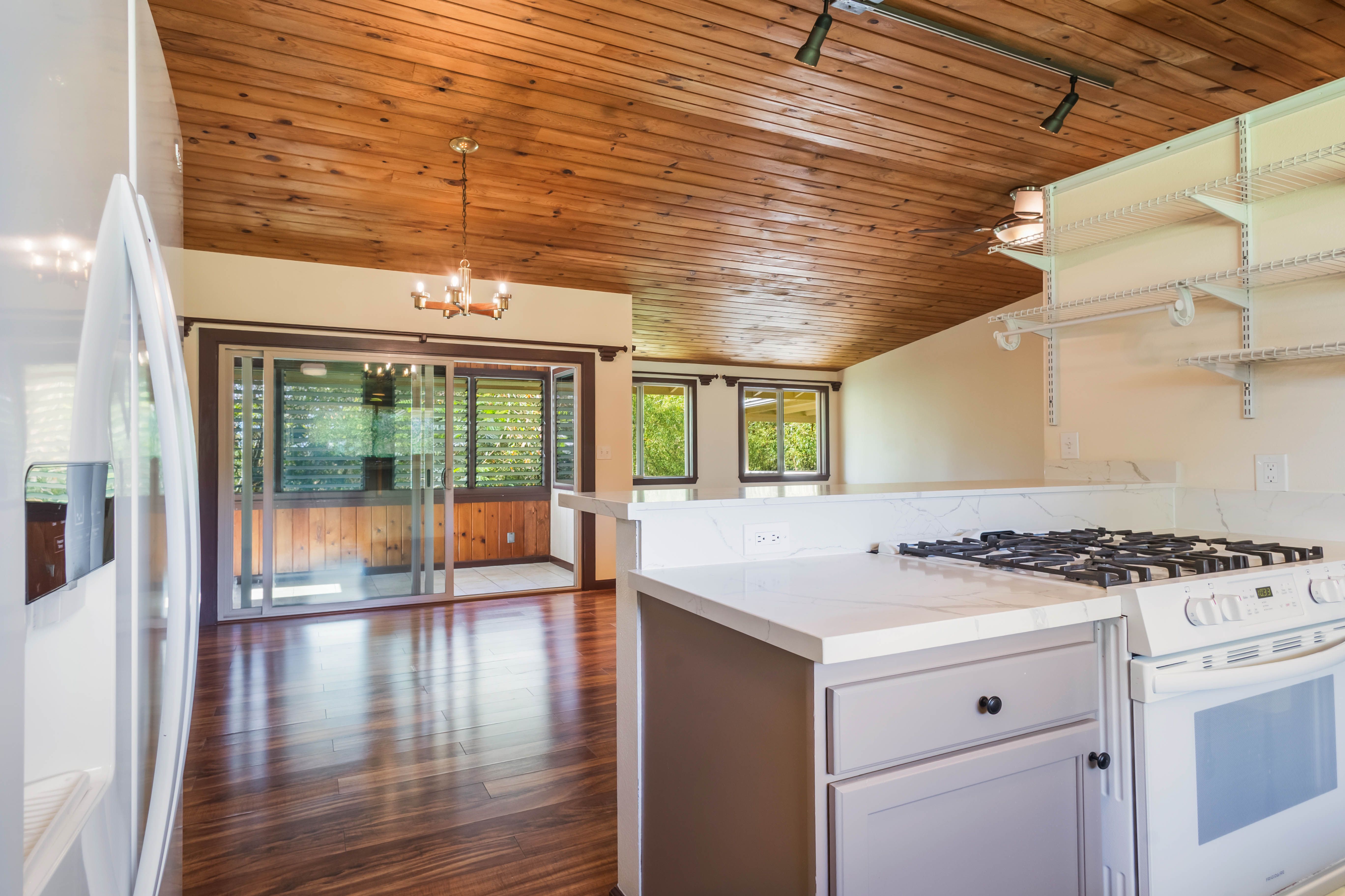 4085 B Noho Road Koloa, HI 96756 - Photo 10 of 30 a kitchen that has a stove and a wooden floor