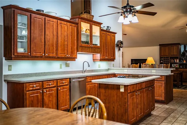 a living room with stainless steel appliances granite countertop lots of furniture and a kitchen view