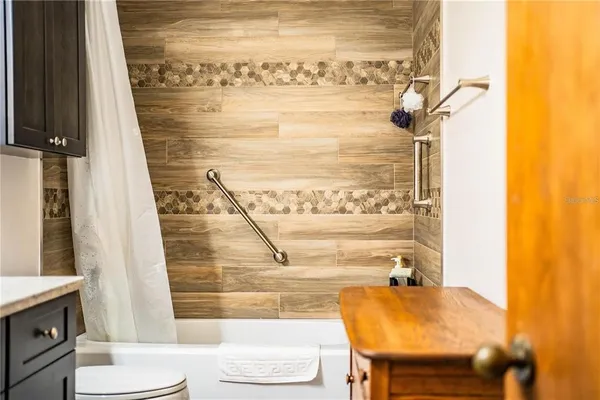 a yellow house with trees in front of it