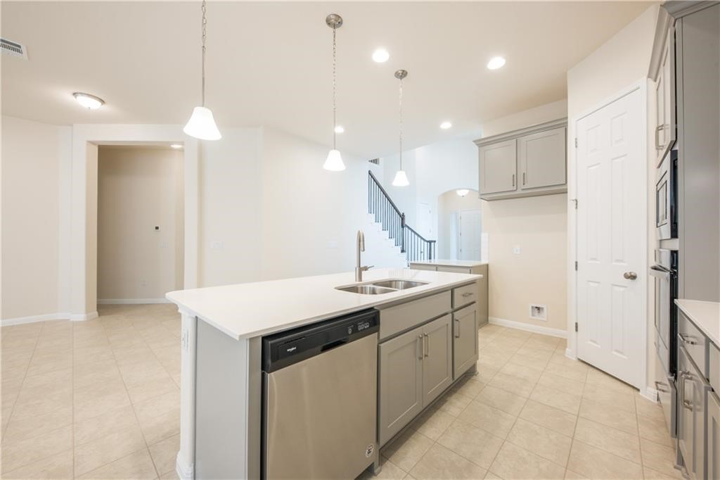 a kitchen with a sink a refrigerator and window