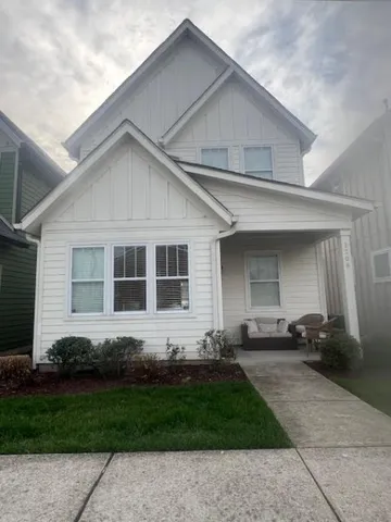 a front view of a house with a garden