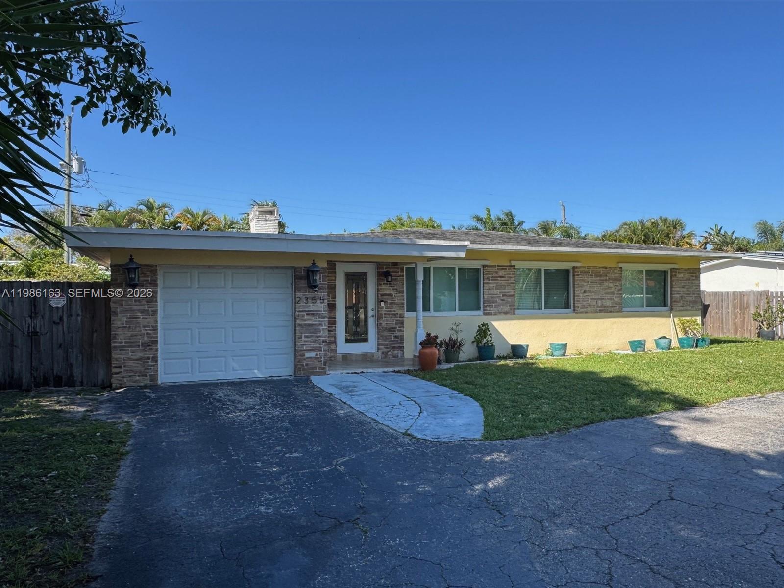 2355 Southeast 7th Street Pompano Beach, FL 33062 - Photo 1 of 31 a front view of a house with a garden and yard