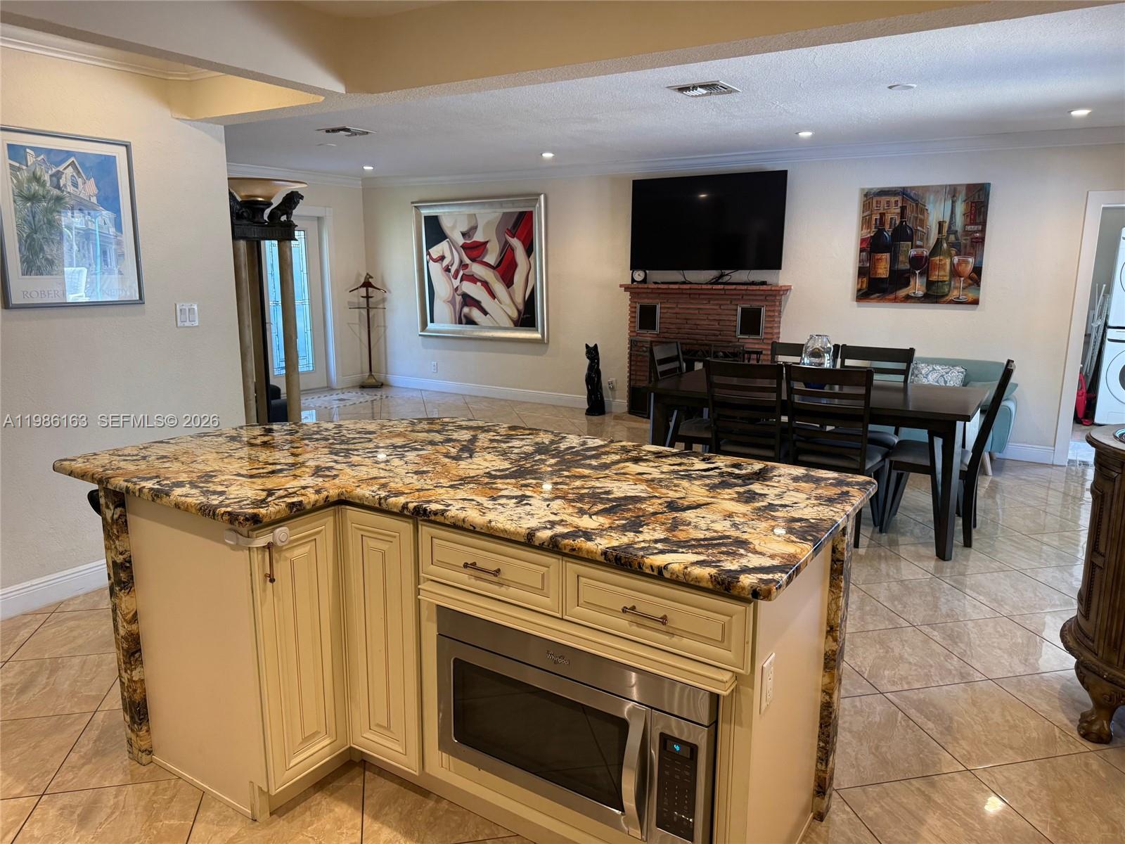2355 Southeast 7th Street Pompano Beach, FL 33062 - Photo 11 of 31 a kitchen with a stove and a flat screen tv