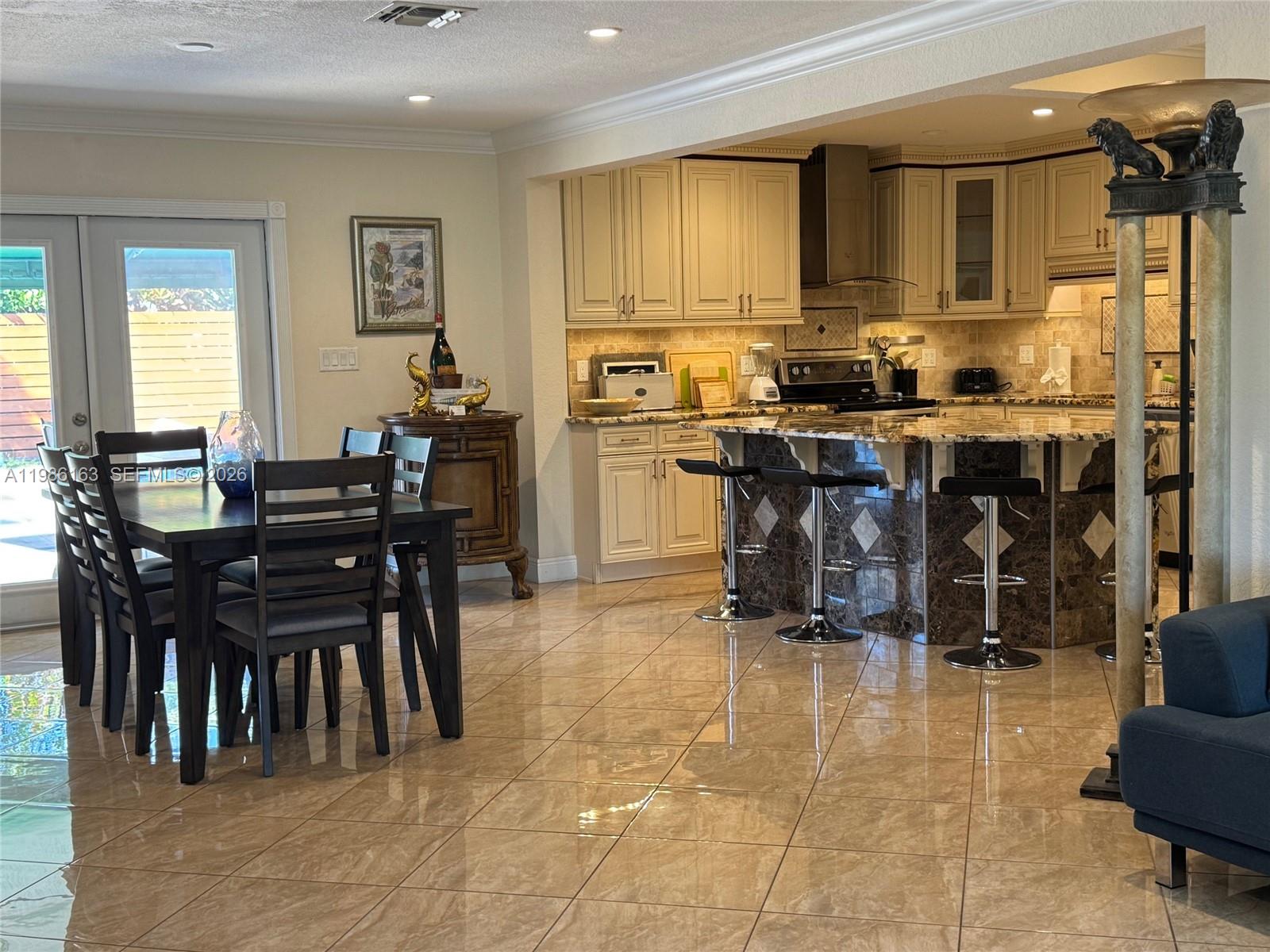 2355 Southeast 7th Street Pompano Beach, FL 33062 - Photo 14 of 31 a kitchen with a dining table and chairs