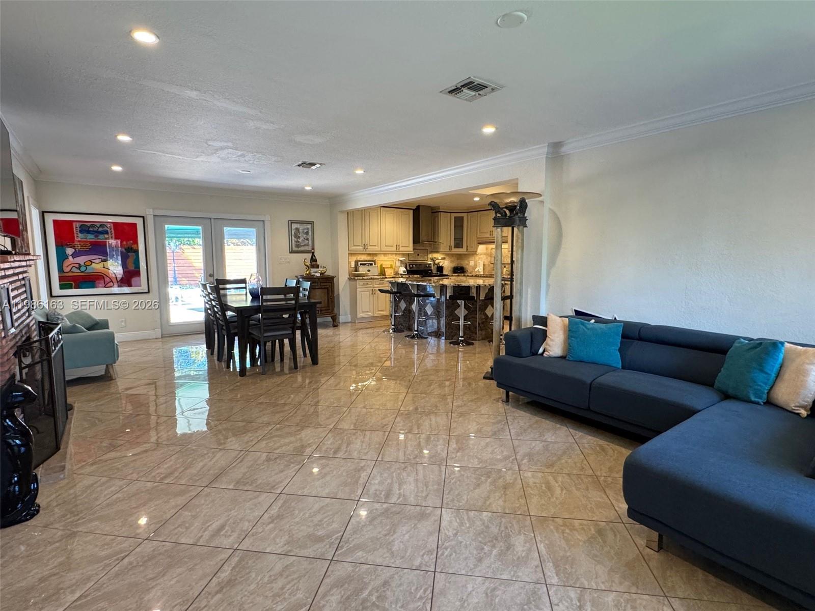 2355 Southeast 7th Street Pompano Beach, FL 33062 - Photo 16 of 31 a living room with furniture a dining table and a flat screen tv