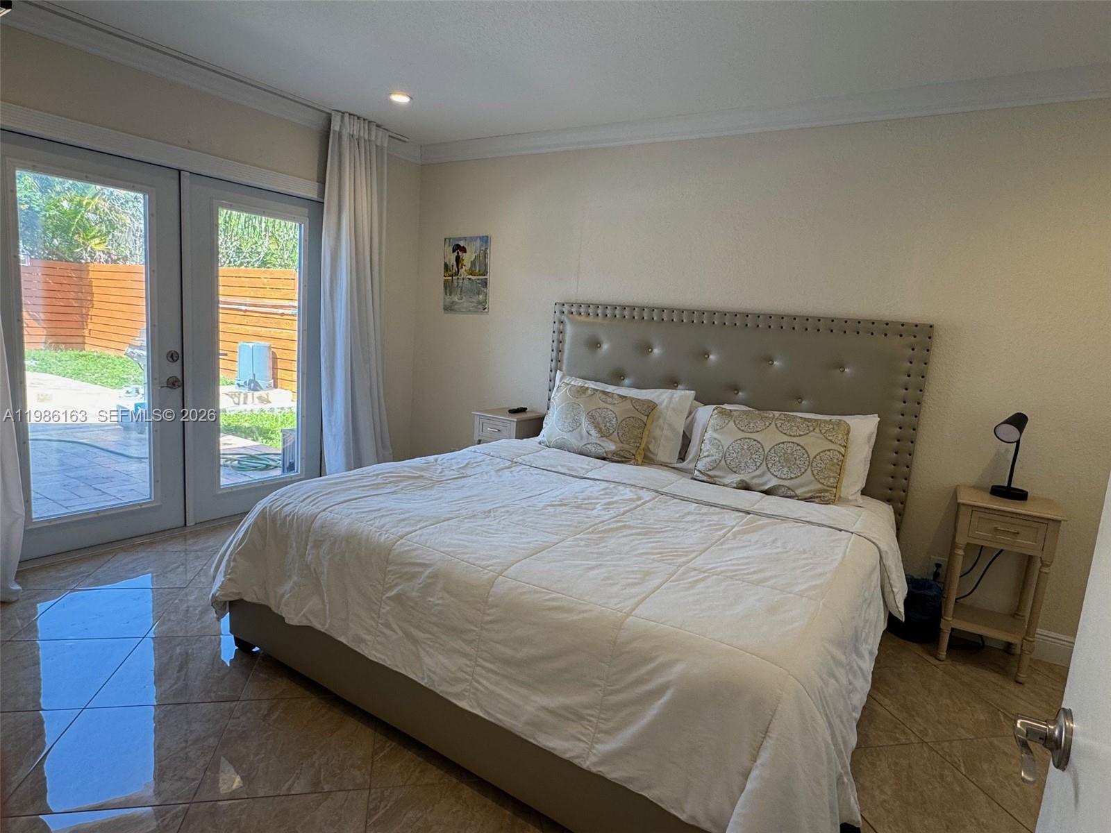 2355 Southeast 7th Street Pompano Beach, FL 33062 - Photo 17 of 31 a bedroom with a bed and large window