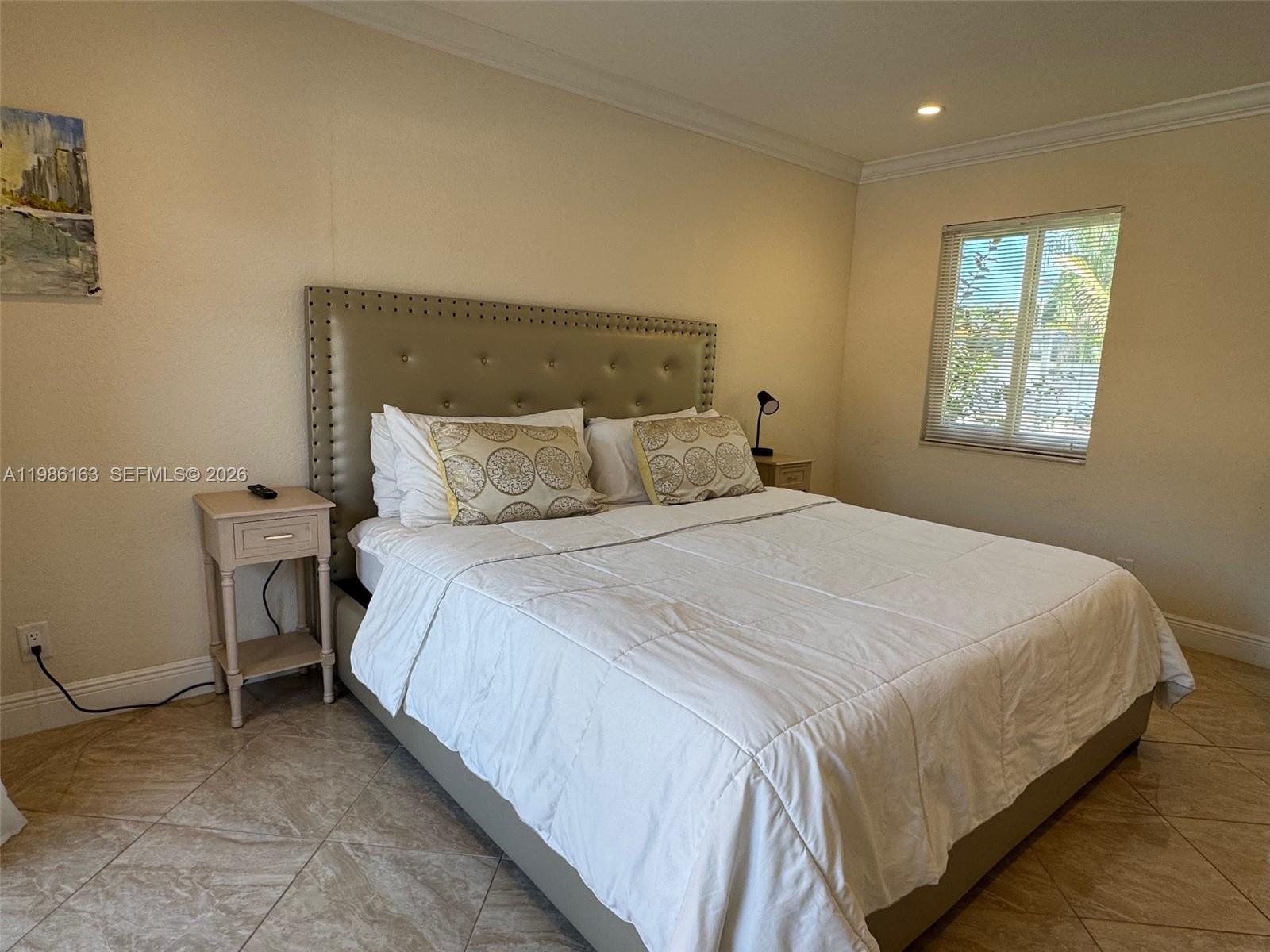 2355 Southeast 7th Street Pompano Beach, FL 33062 - Photo 18 of 31 a bedroom with a bed and a window