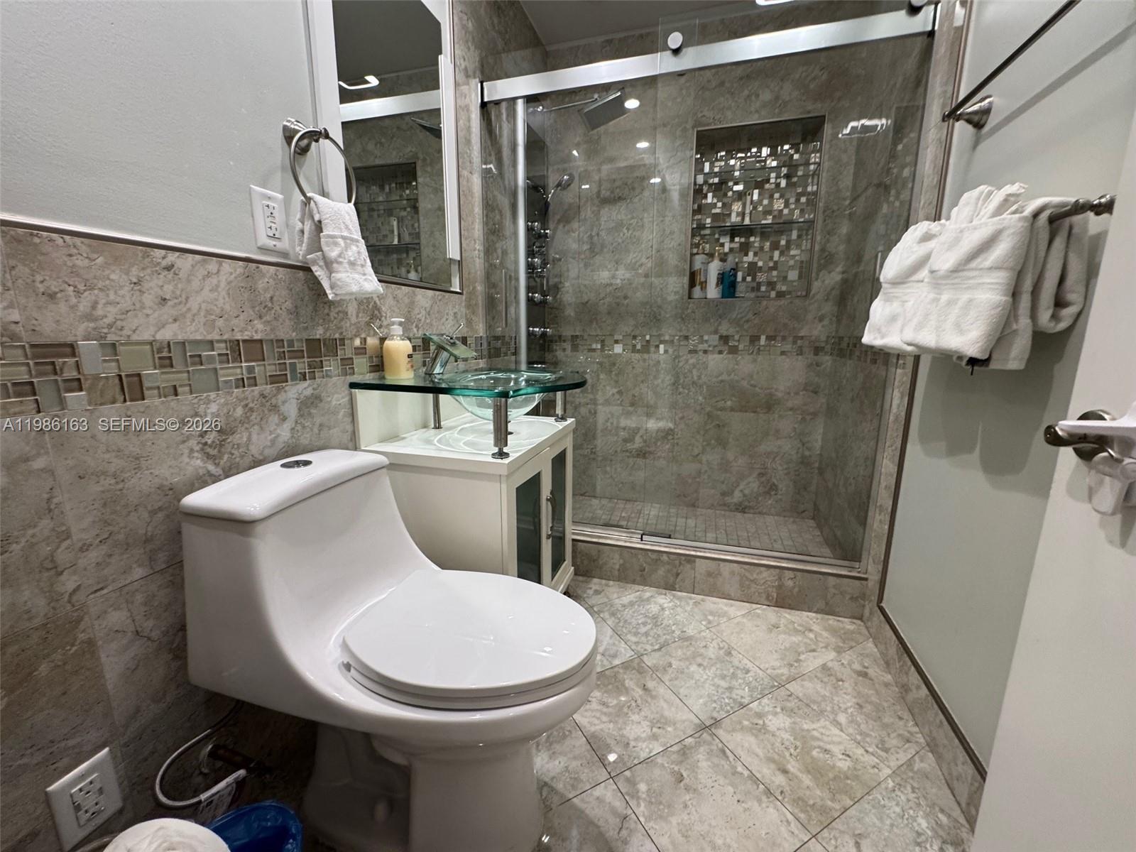 2355 Southeast 7th Street Pompano Beach, FL 33062 - Photo 20 of 31 a white toilet sitting next to a bathroom sink
