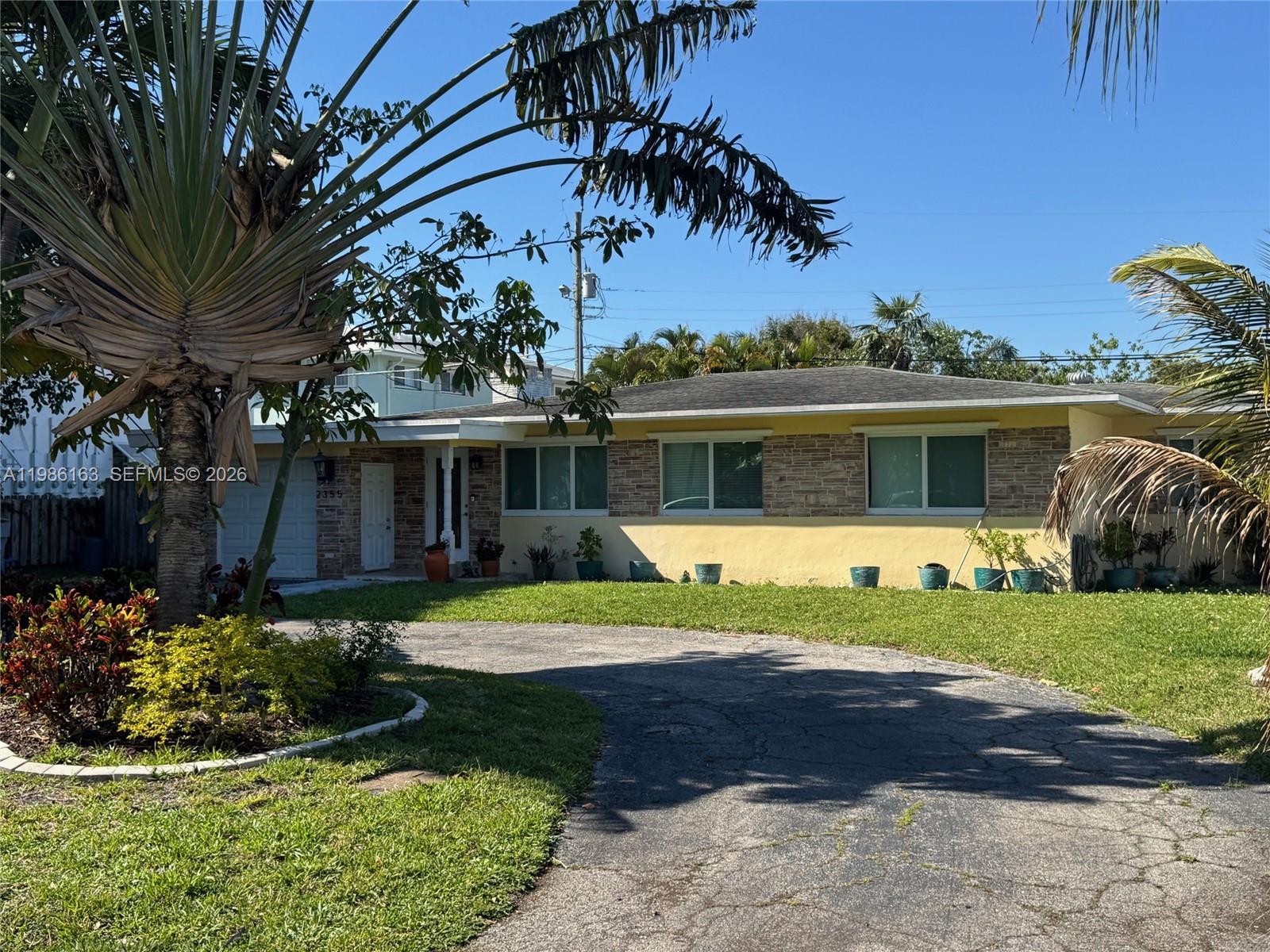 2355 Southeast 7th Street Pompano Beach, FL 33062 - Photo 2 of 31 a front view of a house with a yard and porch