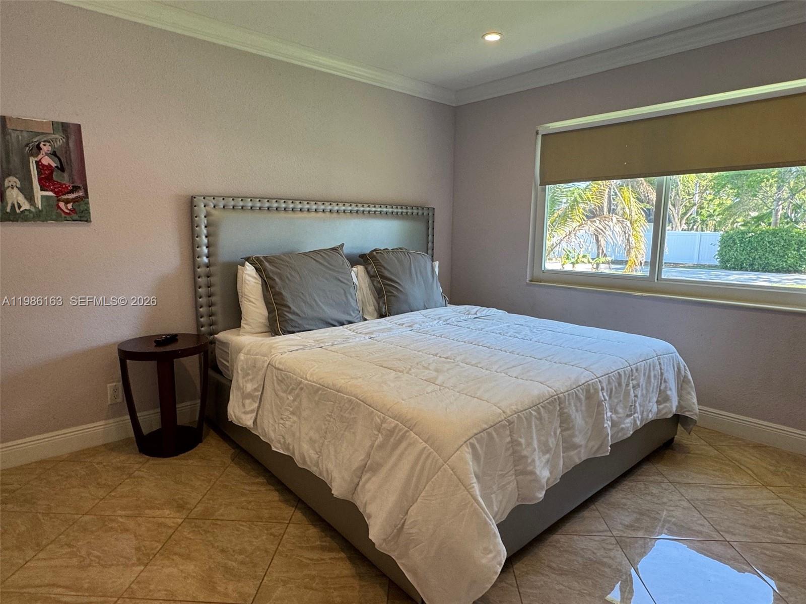 2355 Southeast 7th Street Pompano Beach, FL 33062 - Photo 22 of 31 a large bed sitting in a bedroom next to a window