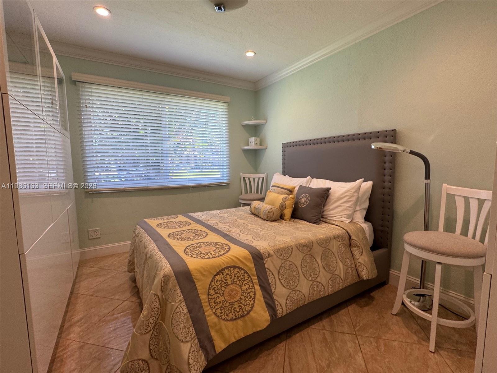 2355 Southeast 7th Street Pompano Beach, FL 33062 - Photo 25 of 31 a bedroom with a bed and a window