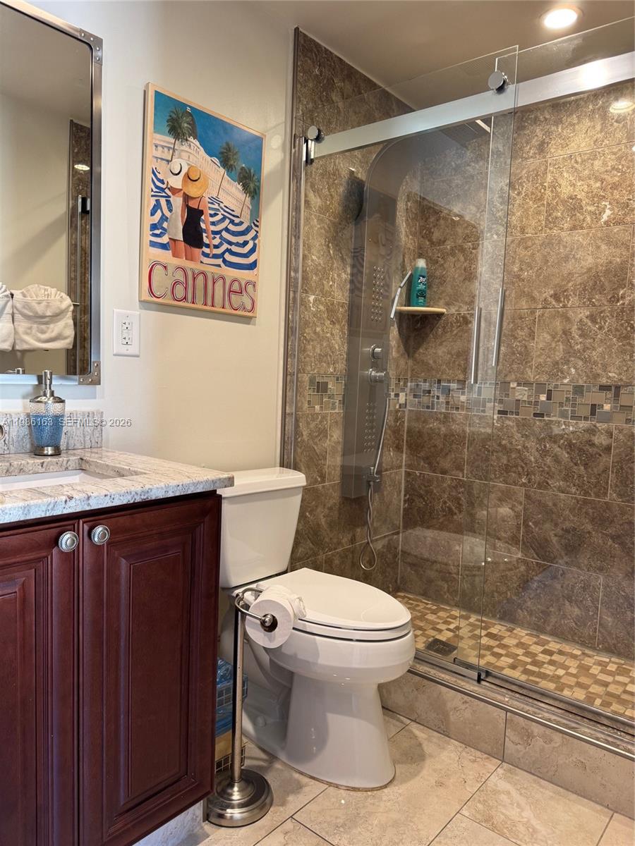 2355 Southeast 7th Street Pompano Beach, FL 33062 - Photo 27 of 31 a bathroom with a sink a toilet and shower