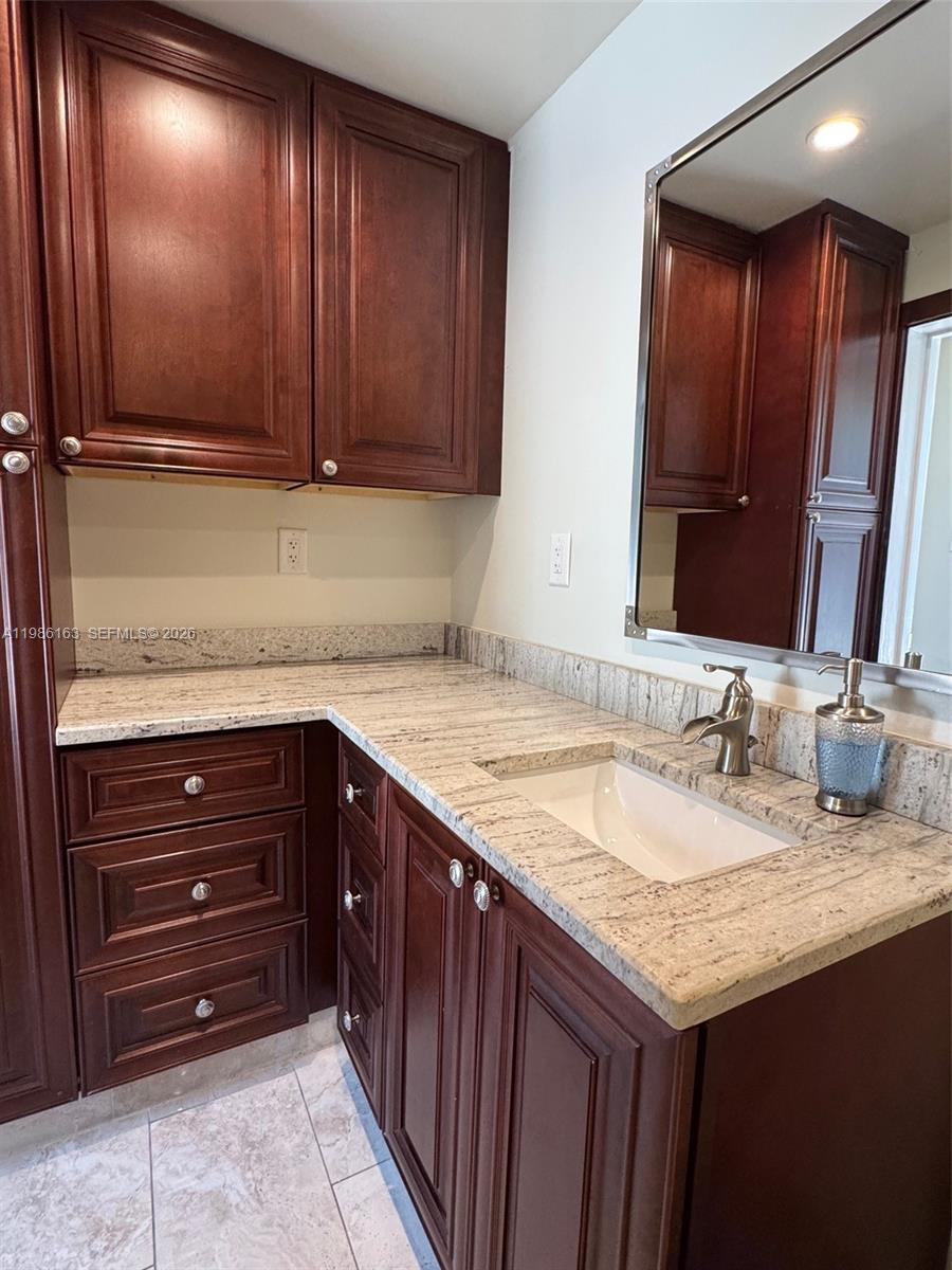 2355 Southeast 7th Street Pompano Beach, FL 33062 - Photo 28 of 31 a bathroom with a granite countertop sink and a mirror