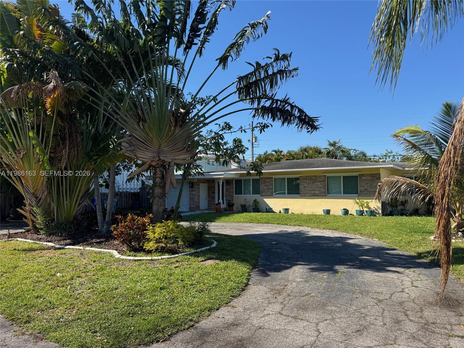 2355 Southeast 7th Street Pompano Beach, FL 33062 - Photo 3 of 31 a front view of a house with garden